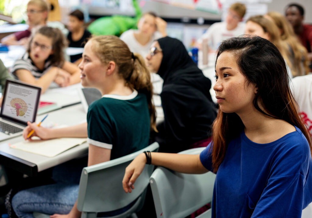 Group of students learning in classroom